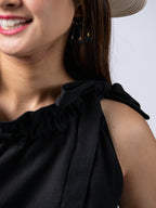Swahlee creates a handmade capsule wardrobe of clothing essentials made in India using sustainable production and natural fabrics. The Tie-Neck Halter Top in Black. Bow detail.