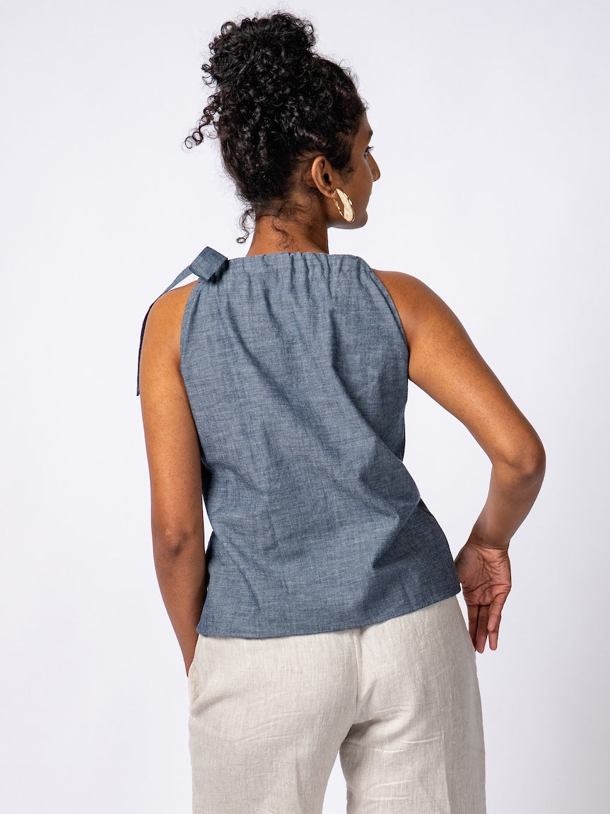 Swahlee creates a handmade capsule wardrobe of clothing essentials made in India using sustainable production and natural fabrics. The Tie-Neck Halter Top in Chambray. 