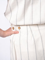 Swahlee creates a handmade capsule wardrobe of clothing essentials made in India using sustainable production and natural fabrics. The Wrap Maxi Skirt in Natural with Sage Stripes. Coconut button detail.