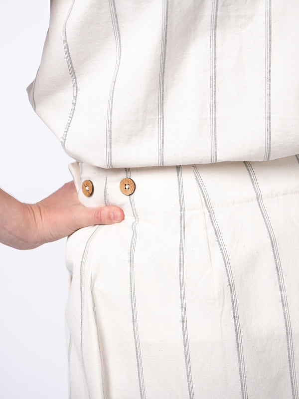 Swahlee creates a handmade capsule wardrobe of clothing essentials made in India using sustainable production and natural fabrics. The Wrap Maxi Skirt in Natural with Sage Stripes. Coconut button detail.