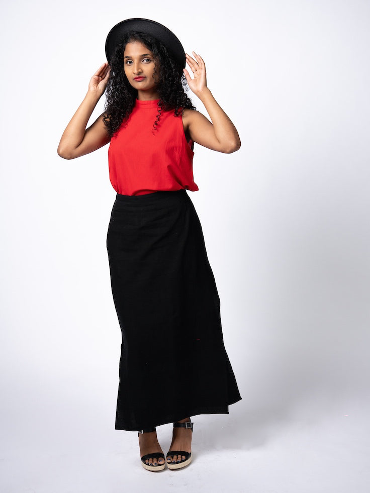Swahlee creates a handmade capsule wardrobe of clothing essentials made in India using sustainable production and natural fabrics. The Wrap Maxi Skirt in Black.
