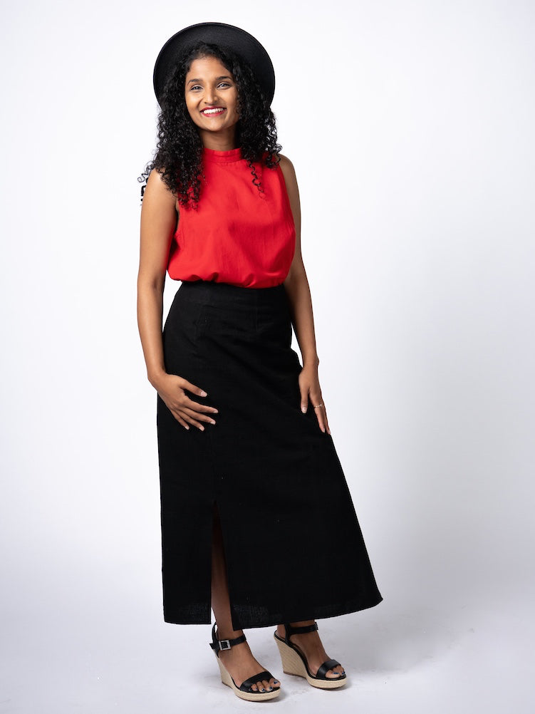 Swahlee creates a handmade capsule wardrobe of clothing essentials made in India using sustainable production and natural fabrics. The Wrap Maxi Skirt in Black.