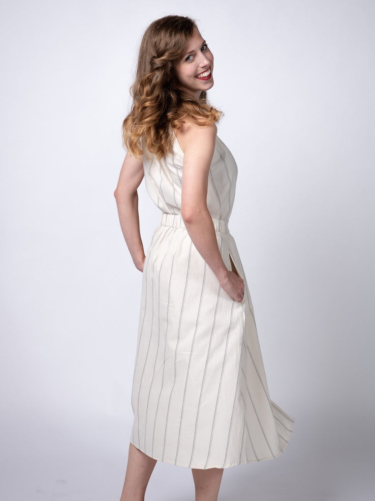 Swahlee creates a handmade capsule wardrobe of clothing essentials made in India using sustainable production and natural fabrics. The Button Midi Skirt in Natural with Sage Stripes..