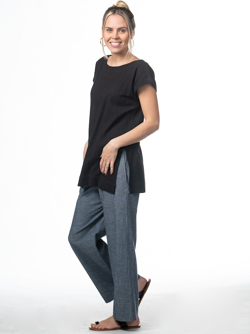 Swahlee creates a handmade capsule wardrobe of clothing essentials made in India using sustainable production and natural fabrics. The Kaftan Tunic in Sheer Striped Black.