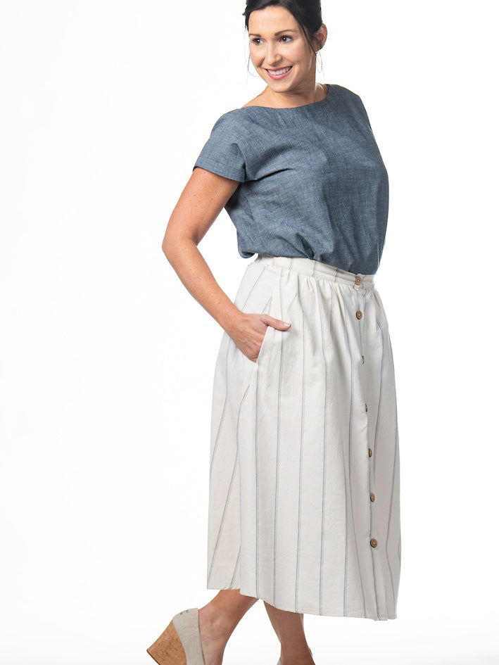 Swahlee creates a handmade capsule wardrobe of clothing essentials made in India using sustainable production and natural fabrics. The Button Midi Skirt in Natural with Sage Stripes.