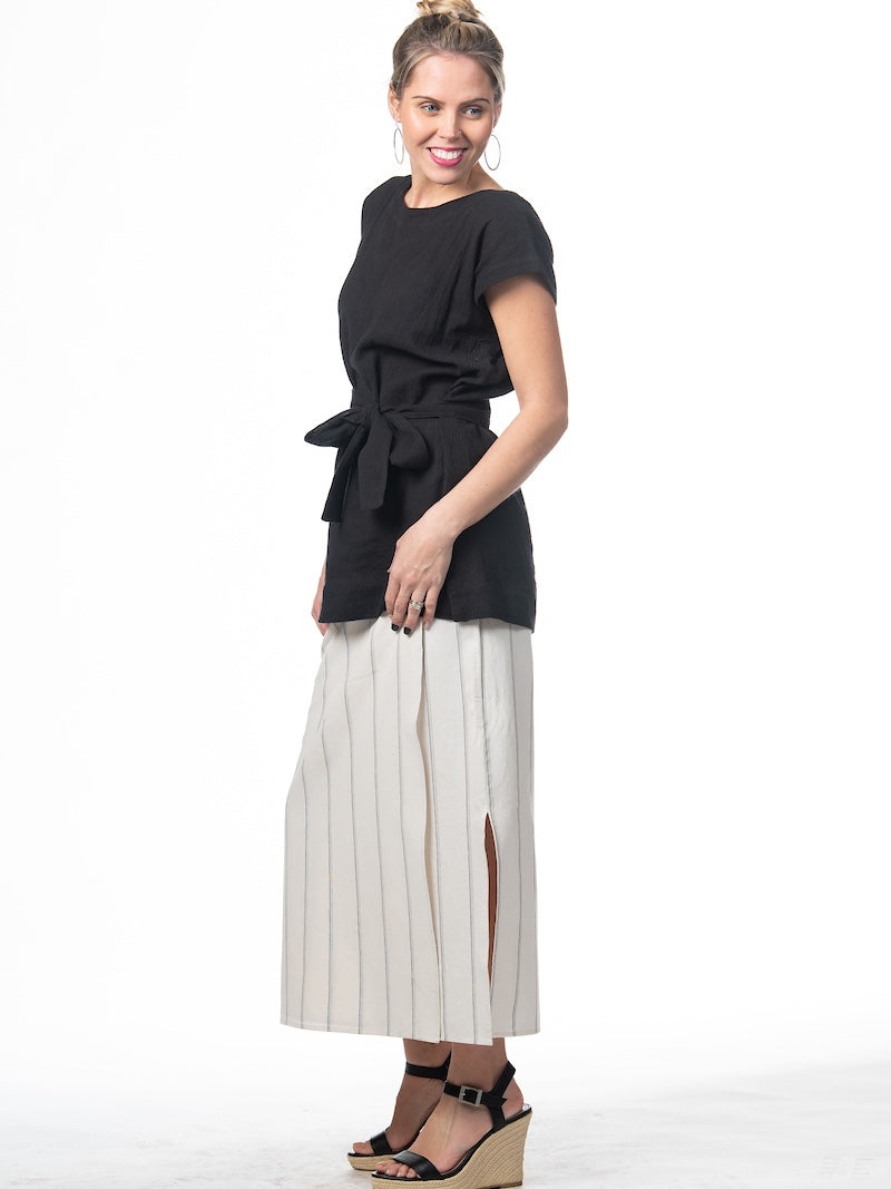 Swahlee creates a handmade capsule wardrobe of clothing essentials made in India using sustainable production and natural fabrics. The Wrap Maxi Skirt in Natural with Sage Stripes.