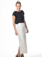 Swahlee creates a handmade capsule wardrobe of clothing essentials made in India using sustainable production and natural fabrics. The Wrap Maxi Skirt in Natural with Sage Stripes.