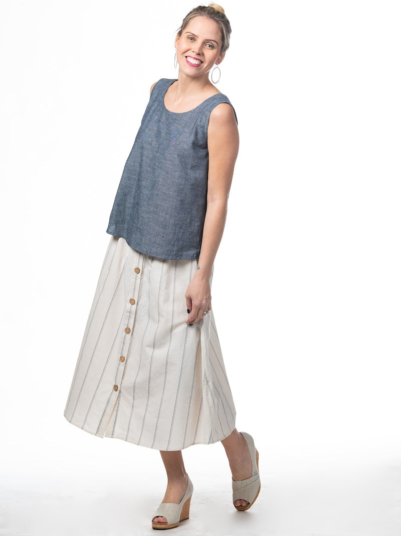 Swahlee creates a handmade capsule wardrobe of clothing essentials made in India using sustainable production and natural fabrics. The Button Midi Skirt in Natural with Sage Stripes.