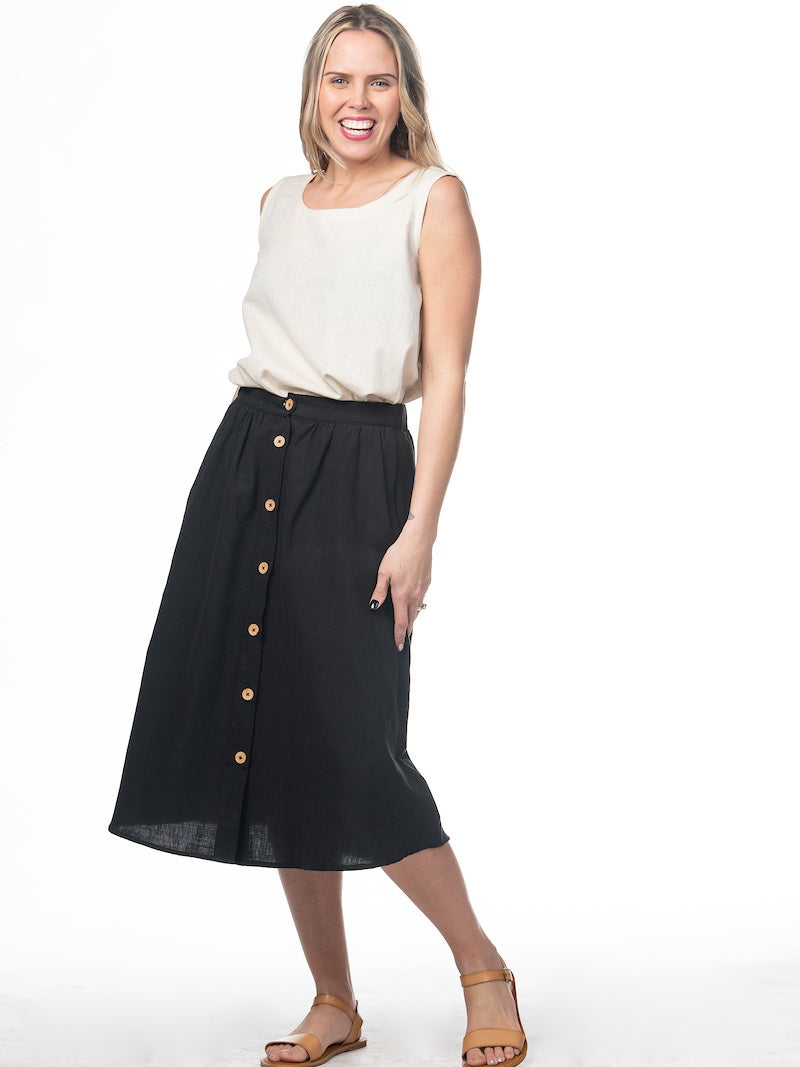 Swahlee creates a handmade capsule wardrobe of clothing essentials made in India using sustainable production and natural fabrics. The Button Midi Skirt in Black.